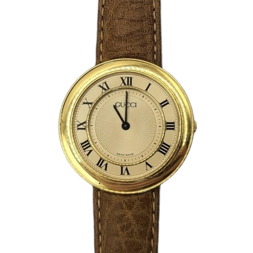 38A - GUCCI, AN 18CT GOLD DISCO VOLANTE' GENT’S WRISTWATCH
Cream tone dial, the case marked ‘008’, on a br... 