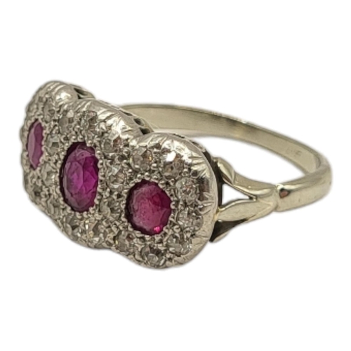 53A - AN EARLY 20TH CENTURY WHITE METAL ,RUBY AND DIAMOND CLUSTER RING
Three graduated oval cut stone edge... 
