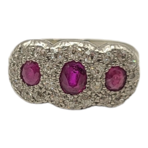 53A - AN EARLY 20TH CENTURY WHITE METAL ,RUBY AND DIAMOND CLUSTER RING
Three graduated oval cut stone edge... 