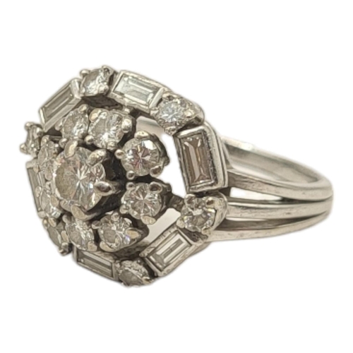 54A - AN ART DECO WHITE METAL AND DIAMOND CLUSTER RING
The arrangement of round cut diamonds edged with ba... 