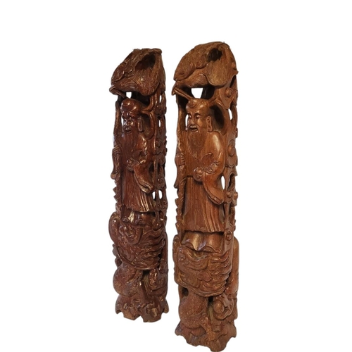 107 - A PAIR OF LATE QING DYNASTY CHINESE HARDWOOD CARVINGS OF SHOU LAO IMMORTALS 
Each dressed in flowing... 