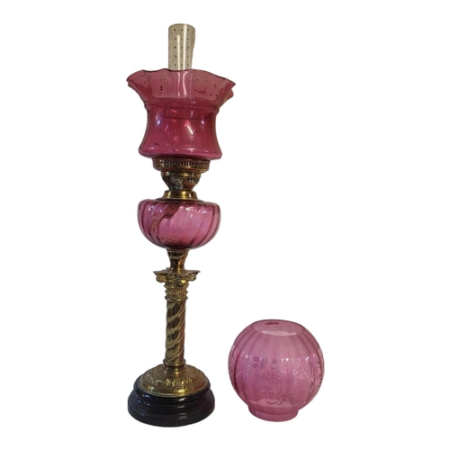 107A - A VICTORIAN CRANBERRY GLASS AND BRASS OIL LAMP
Having a fluted cranberry glass shade and oil well on... 