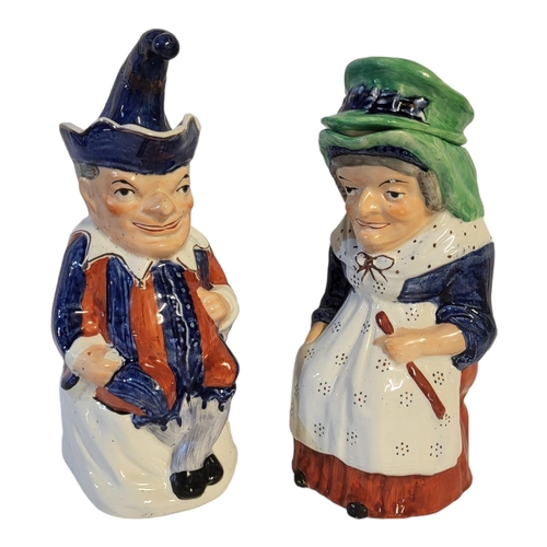 125 - A PAIR OF PUNCH AND JUDY STAFFORDSHIRE SEMI PORCELAIN CHARACTER JUGS AND COVERS BY WILLIAM KENT, CIR... 