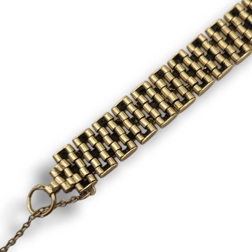 26 - A 9CT GOLD LADIES’ BRACELET 
Each link with a pierced geometrical foliage border. 
(length 18.5cm)