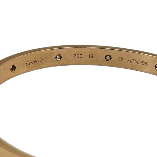 35A - CARTIER, AN 18CT GOLD AND DIAMOND LOVE BANGLE
Set with ten round cut diamonds and screw fasteners, m... 
