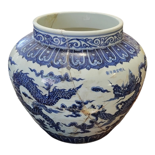 494 - A LARGE CHINESE  BLUE AND WHITE SIGNED MING JARDINIERE, decorated with imperial five toed dragons
44... 