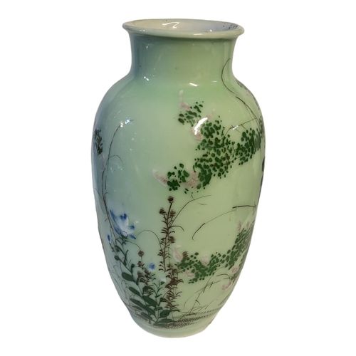 498 - A CHINESE LATE QING DYNASTY CELADON GLAZED BALUSTER VASE
With everted rim applied with raised decora... 