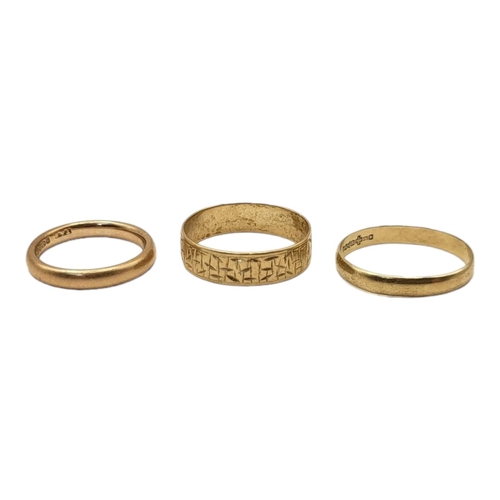 61A - A COLLECTION OF THREE VINTAGE GOLD WEDDING BANDS
To include a band with textured design.
(size O)

C... 