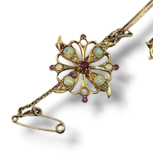 64 - AN EARLY 20TH CENTURY YELLOW METAL, OPAL AND RUBY PENDANT NECKLACE
Having an arrangement of gem ston... 