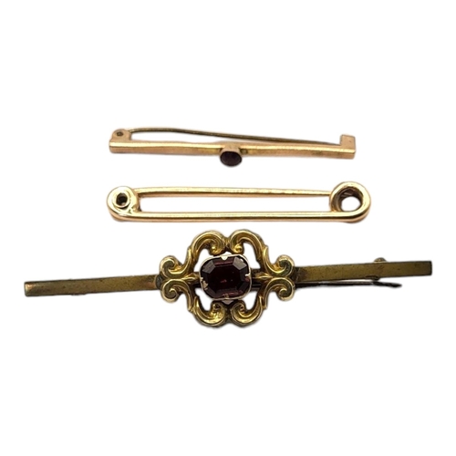 71 - A COLLECTION OF THREE EARLY 20TH CENTURY YELLOW METAL BROOCHES
To include two set with garnets and o... 