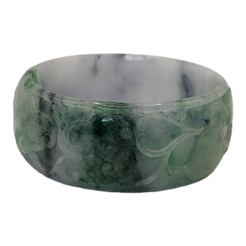 85 - A CHINESE JADE 'DRAGON' BANGLE
Carved within an oval cartouche with peaches and fauna.
(approx 7cm)
... 