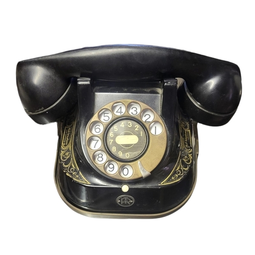 332B - AN EARLY FRENCH BELL TELEPHONE COMPANY BAKELITE TELEPHONE
With gilt decoration, Circa 1930.
(20cm x ... 