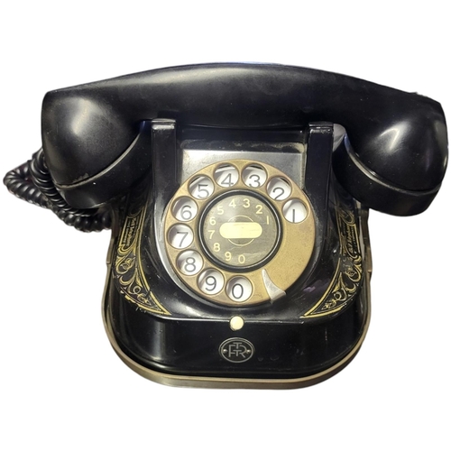 332B - AN EARLY FRENCH BELL TELEPHONE COMPANY BAKELITE TELEPHONE
With gilt decoration, Circa 1930.
(20cm x ... 