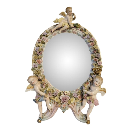 103 - SITZENDORF, THURINGIA, A BAROQUE STYLE LADIES' CHERUB WALL MIRROR
Hard paste porcelain mounted mirro... 