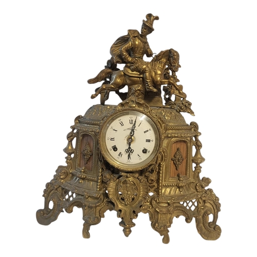 107 - A 20TH CENTURY BRASS FIGURAL MANTLE CLOCK
A Tudor equestrian figure on a scrolled and pierced case, ... 