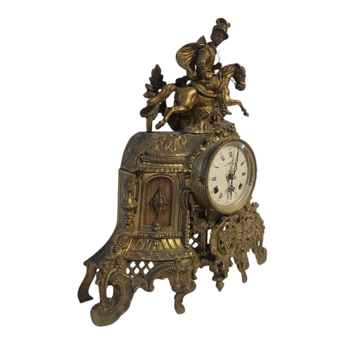 107 - A 20TH CENTURY BRASS FIGURAL MANTLE CLOCK
A Tudor equestrian figure on a scrolled and pierced case, ... 