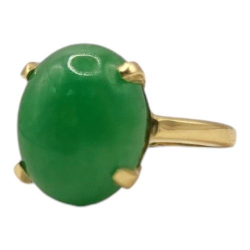 12A - AN 18CT GOLD AND JADE RING
Cabochon cut and untreated jade stone.
(approx 1.2cm x 1.5cm, size M/N)

... 