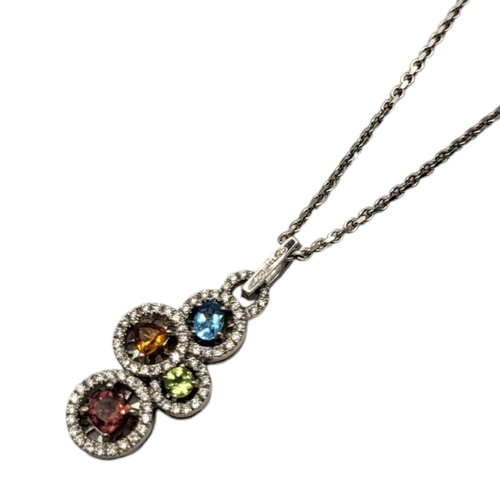 17A - AN 18CT WHITE GOLD, DIAMOND AND GEM SET PENDANT NECKLACE
Having an arrangement of round cut stones e... 