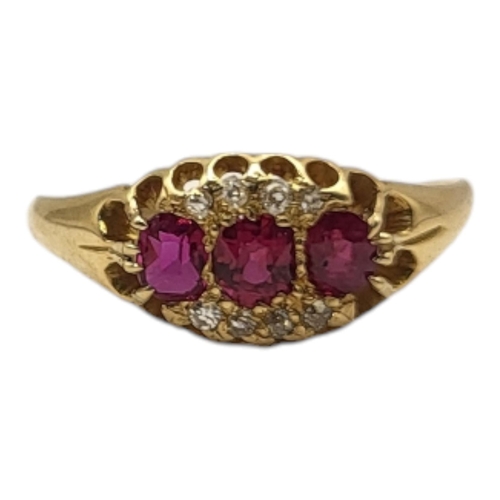 23A - AN EARLY 20TH CENTURY RUBY THREE STONE RING
Set with three oval cut stones edged with diamonds.
(siz... 