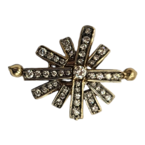 25A - A YELLOW METAL AND DIAMOND CLUSTER DOUBLE CLASP
Having an arrangement of round cut stones in a pierc... 