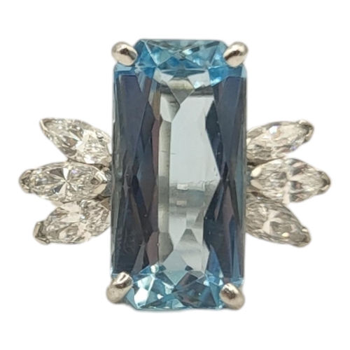 4A - A WHITE METAL, AQUAMARINE AND DIAMOND CLUSTER RING
The rectangular faceted central stone flanked by ... 