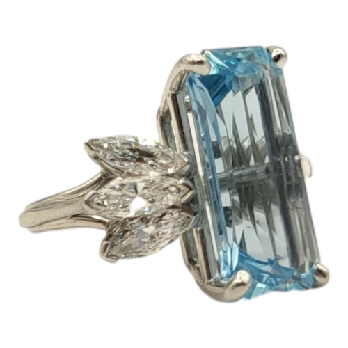 4A - A WHITE METAL, AQUAMARINE AND DIAMOND CLUSTER RING
The rectangular faceted central stone flanked by ... 