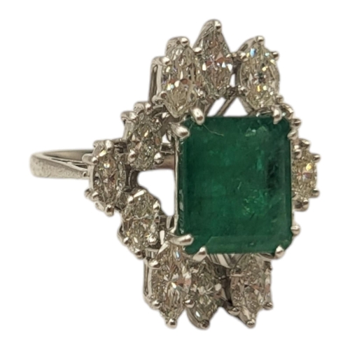 6A - AN 18CT WHITE GOLD, EMERALD AND DIAMOND CLUSTER RING
The central rectangular cut emerald edged with ... 