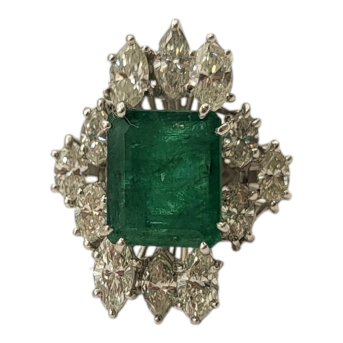 6A - AN 18CT WHITE GOLD, EMERALD AND DIAMOND CLUSTER RING
The central rectangular cut emerald edged with ... 