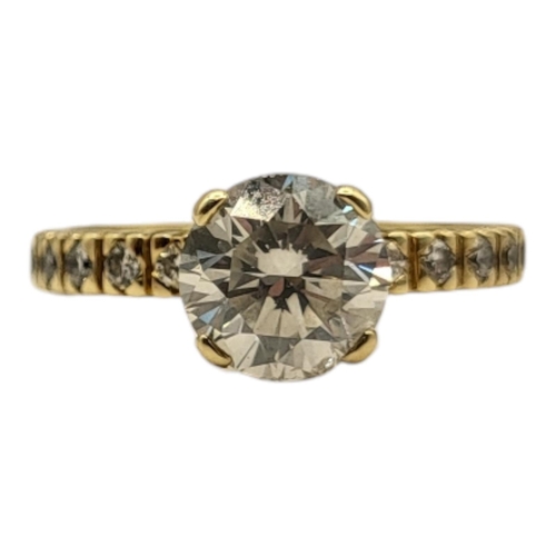 8A - AN 18CT GOLD AND DIAMOND SOLITAIRE RING
The single round cut stone with diamond set shoulders.
(appr... 