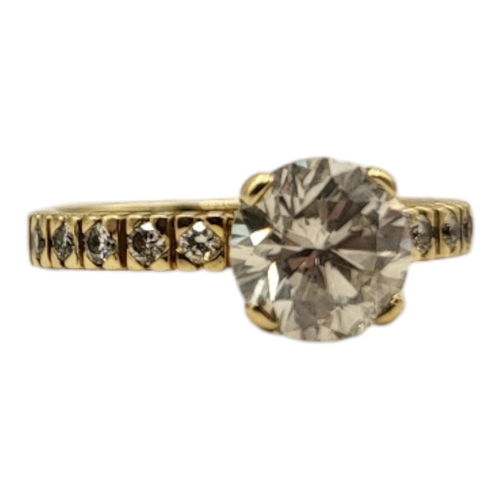 8A - AN 18CT GOLD AND DIAMOND SOLITAIRE RING
The single round cut stone with diamond set shoulders.
(appr... 