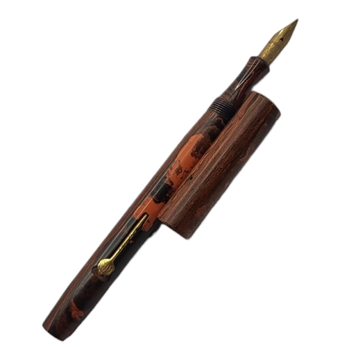 9 - CONWAY STEWART, AN EARLY 20TH CENTURY FOUNTAIN PEN
Having rouge marble effect and 14ct gold nib.
(ap... 