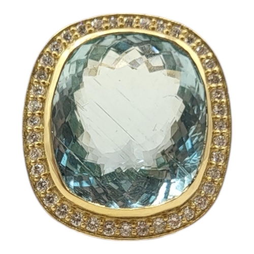 9A - A LARGE 18CT GOLD, AQUAMARINE AND DIAMOND RING
The central oval cut stone edged with diamonds.
(appr... 