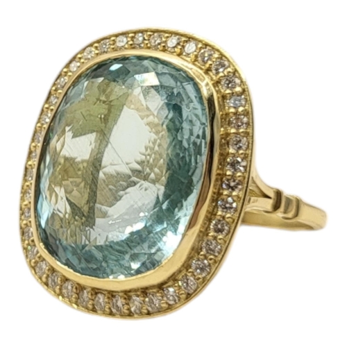 9A - A LARGE 18CT GOLD, AQUAMARINE AND DIAMOND RING
The central oval cut stone edged with diamonds.
(appr... 