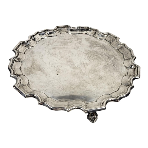 107 - AN EARLY 20TH CENTURY SILVER SALVER
Having a piecrust border and scrolled tripod legs, hallmarked Sh... 