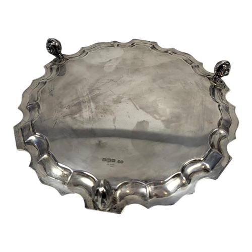 107 - AN EARLY 20TH CENTURY SILVER SALVER
Having a piecrust border and scrolled tripod legs, hallmarked Sh... 