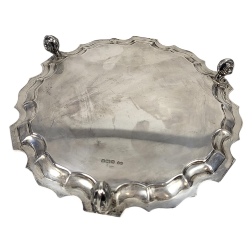 107 - AN EARLY 20TH CENTURY SILVER SALVER
Having a piecrust border and scrolled tripod legs, hallmarked Sh... 