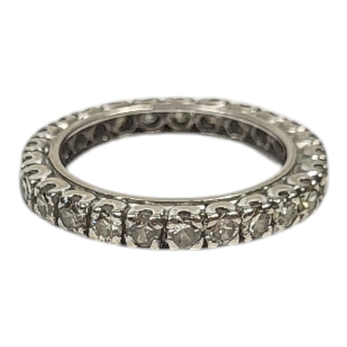 12 - A VINTAGE WHITE METAL AND DIAMOND FULL ETERNITY RING
Having a row of round cut diamonds in a plain d... 