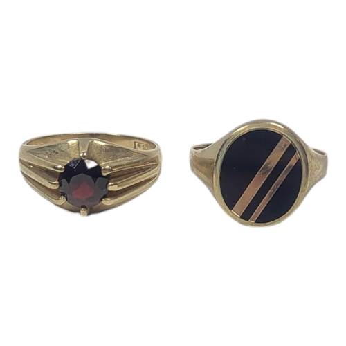 121 - TWO VINTAGE 9CT GOLD GENT’S SIGNET RINGS
Set with a single garnet and black onyx.
(size U)

Conditio... 