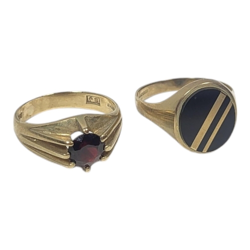 121 - TWO VINTAGE 9CT GOLD GENT’S SIGNET RINGS
Set with a single garnet and black onyx.
(size U)

Conditio... 