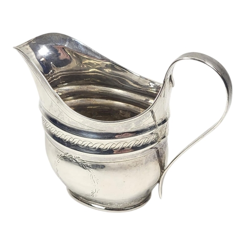 134 - A GEORGIAN NEWCASTLE SILVER CREAM JUG
Helmet form, with single handle and engraved decoration.
(appr... 