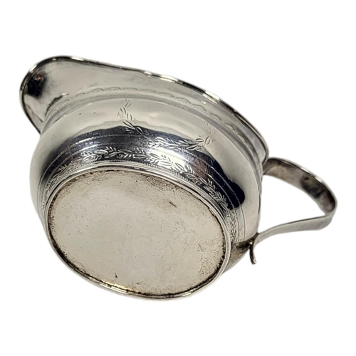 134 - A GEORGIAN NEWCASTLE SILVER CREAM JUG
Helmet form, with single handle and engraved decoration.
(appr... 