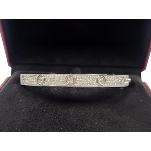 135 - CARTIER, AN 18CT GOLD AND DIAMOND LOVE BRACELET
Set with twelve round cut diamonds with three rows o... 