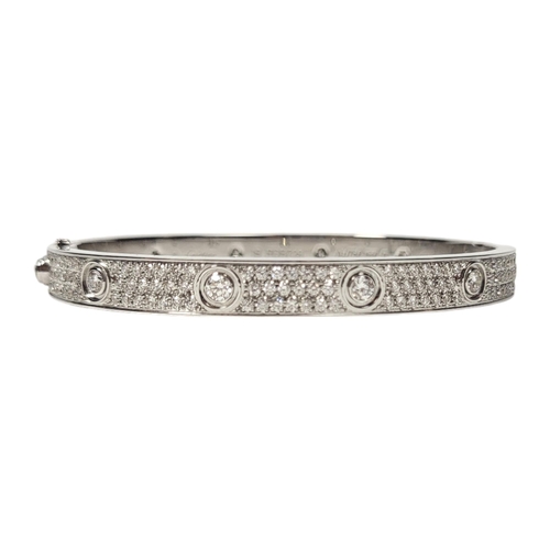 135 - CARTIER, AN 18CT GOLD AND DIAMOND LOVE BRACELET
Set with twelve round cut diamonds with three rows o... 