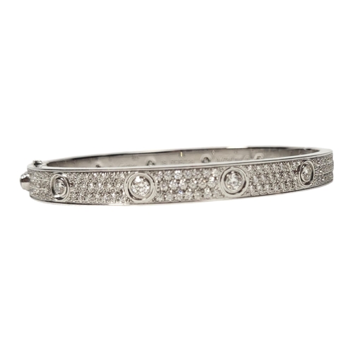 135 - CARTIER, AN 18CT GOLD AND DIAMOND LOVE BRACELET
Set with twelve round cut diamonds with three rows o... 