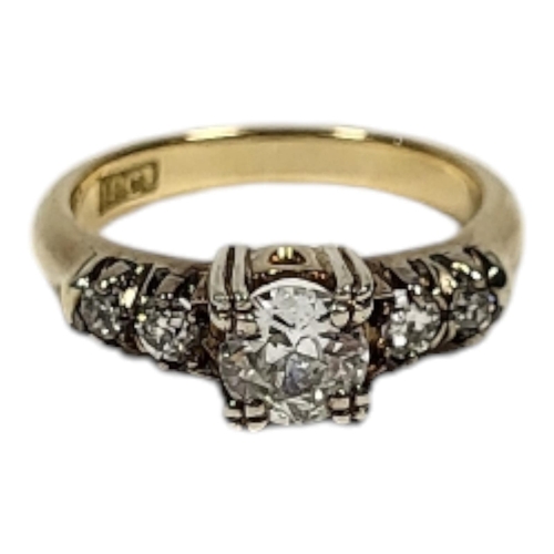 14 - A VINTAGE 18CT GOLD AND DIAMOND FIVE STONE RING
The central round cut diamond flanked by diamond set... 