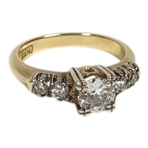 14 - A VINTAGE 18CT GOLD AND DIAMOND FIVE STONE RING
The central round cut diamond flanked by diamond set... 