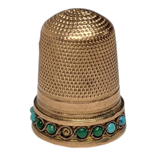 158 - A VICTORIAN 9CT GOLD AND TURQUOISE SEWING THIMBLE
Having a row cabochon cut stones to base.
(approx ... 