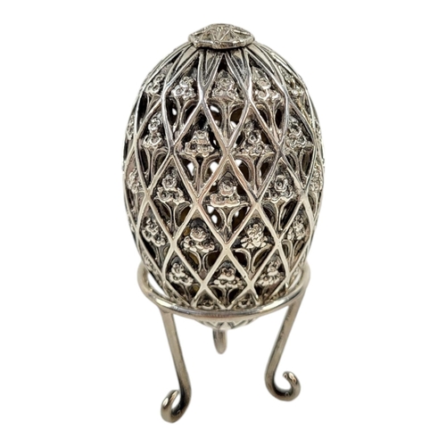 177 - A 20TH CENTURY SILVER NOVELTY EASTER EGG TRINKET BOX AND STAND
Heavy gauge with pierced decoration a... 