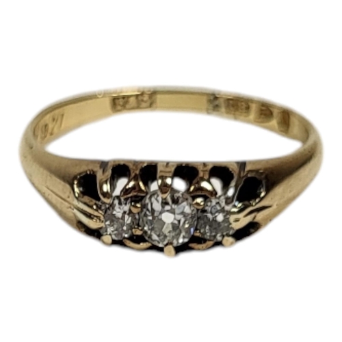 18 - A VINTAGE 18CT GOLD AND DIAMOND THREE STONE RING
Having a row of graduated round cut stones, inscrib... 