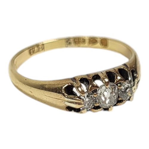 18 - A VINTAGE 18CT GOLD AND DIAMOND THREE STONE RING
Having a row of graduated round cut stones, inscrib... 